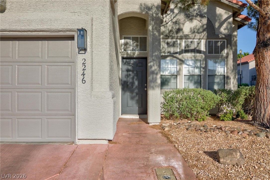 2246 Ramsgate Drive Henderson, NV 89074 - Photo 3 of 36 A welcoming entryway with a contemporary front door and practical garage access awaits.