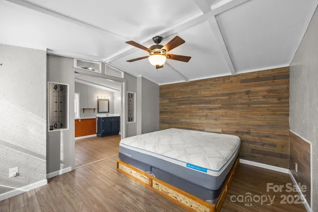a living room with stainless steel appliances furniture and a kitchen view