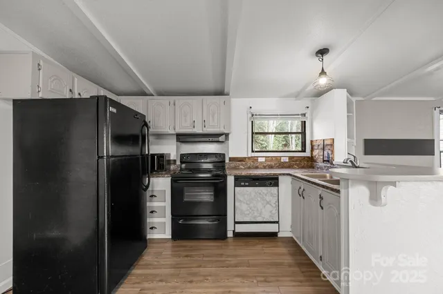 a kitchen with stainless steel appliances a refrigerator and a sink