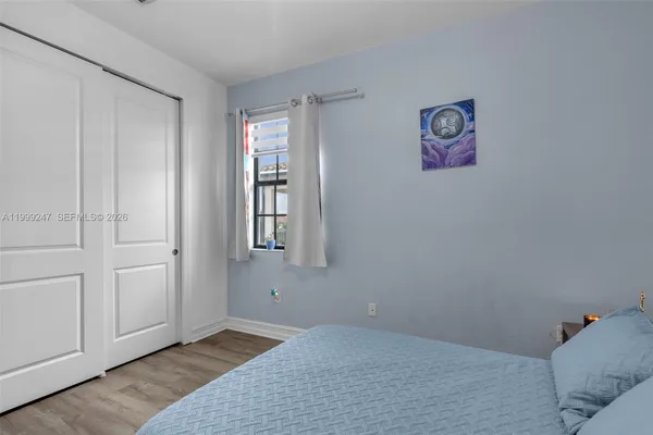 a bedroom with a bed a desk and chair
