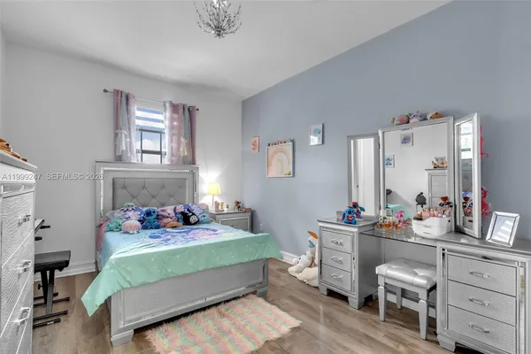 a bedroom with a bed and a lamp
