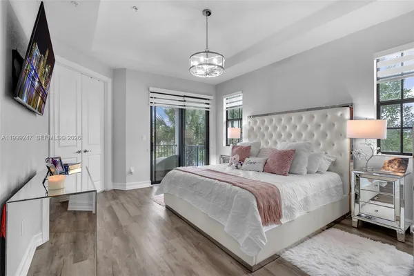 a bedroom with a bed and a chandelier