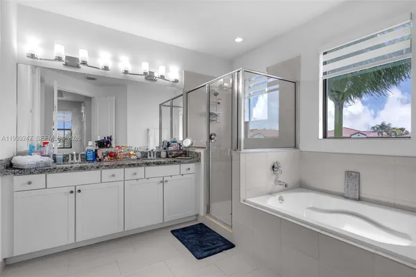 a bathroom with a bathtub and a shower