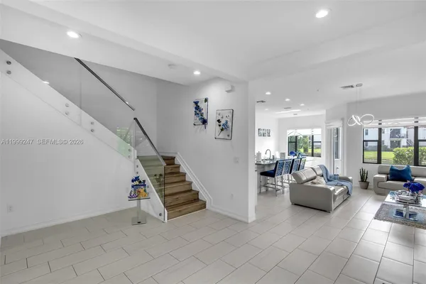 a living room with furniture and stairs