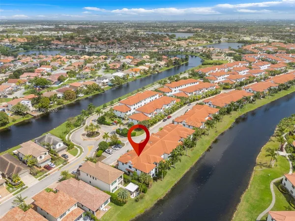 an aerial view of residential building and lake