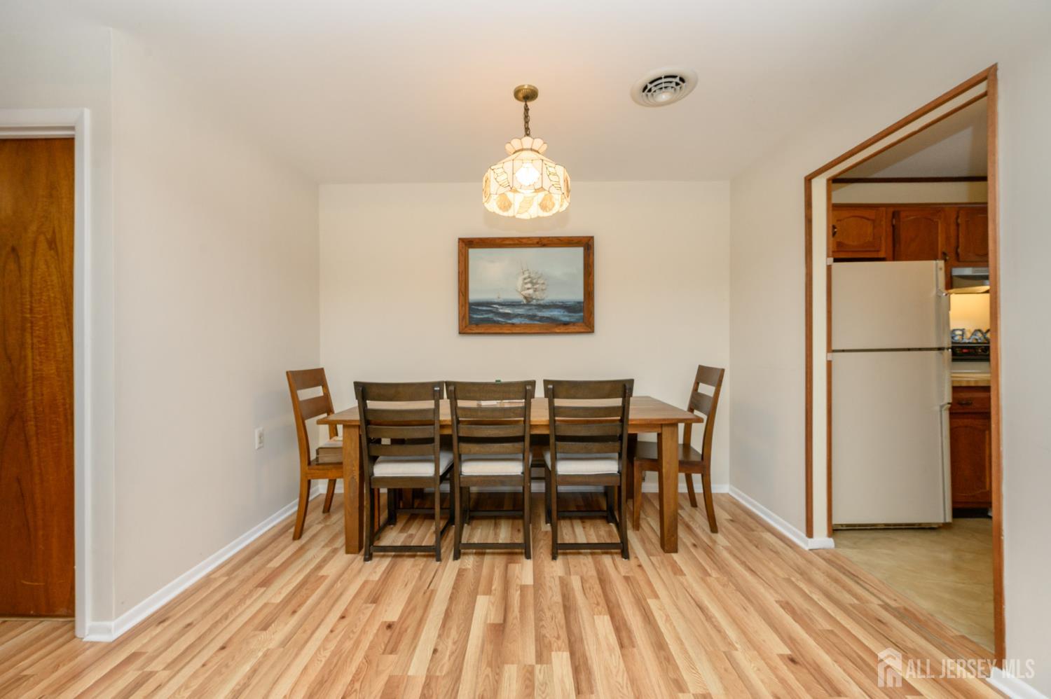 38 Cranberry Road Manahawkin, NJ 08050 - Photo 11 of 23 a view of a dining room with furniture wooden floor and a window