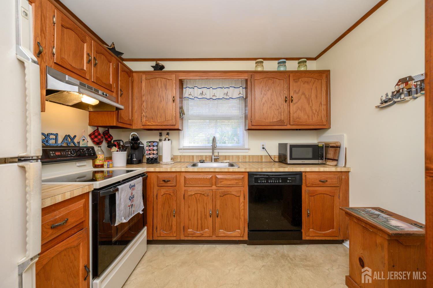 38 Cranberry Road Manahawkin, NJ 08050 - Photo 13 of 23 a kitchen with stainless steel appliances granite countertop a stove sink and cabinets