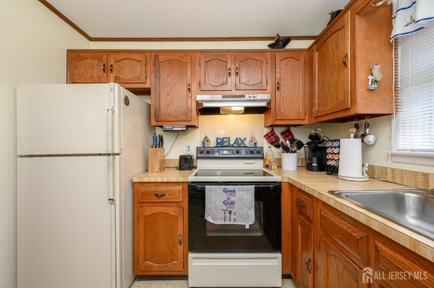 38 Cranberry Road Manahawkin, NJ 08050 - Photo 14 of 23 a kitchen with stainless steel appliances granite countertop a refrigerator a stove a sink and dishwasher