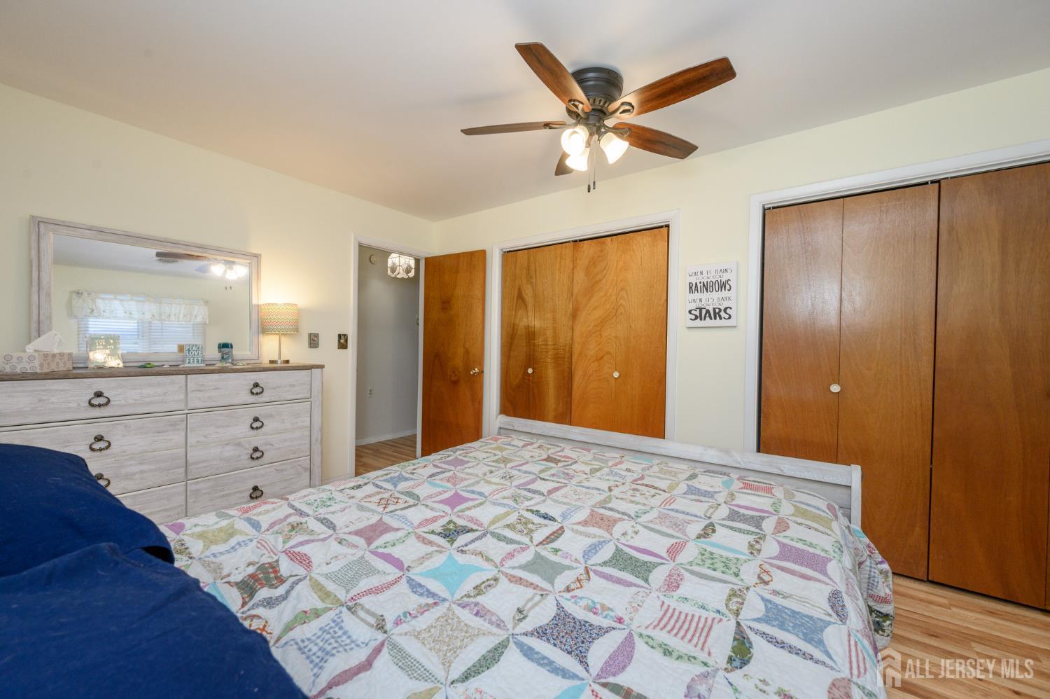 38 Cranberry Road Manahawkin, NJ 08050 - Photo 17 of 23 a spacious bedroom with a large bed and a chandelier