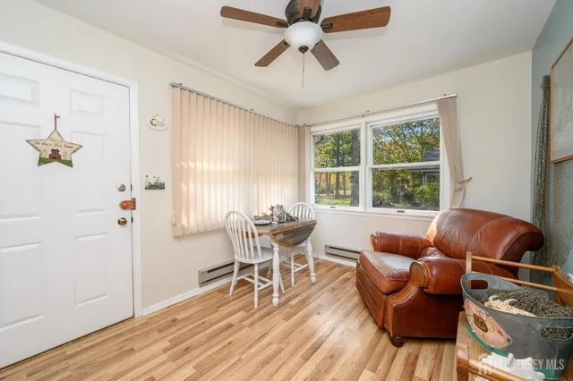 a dining room with furniture a chandelier and wooden floor