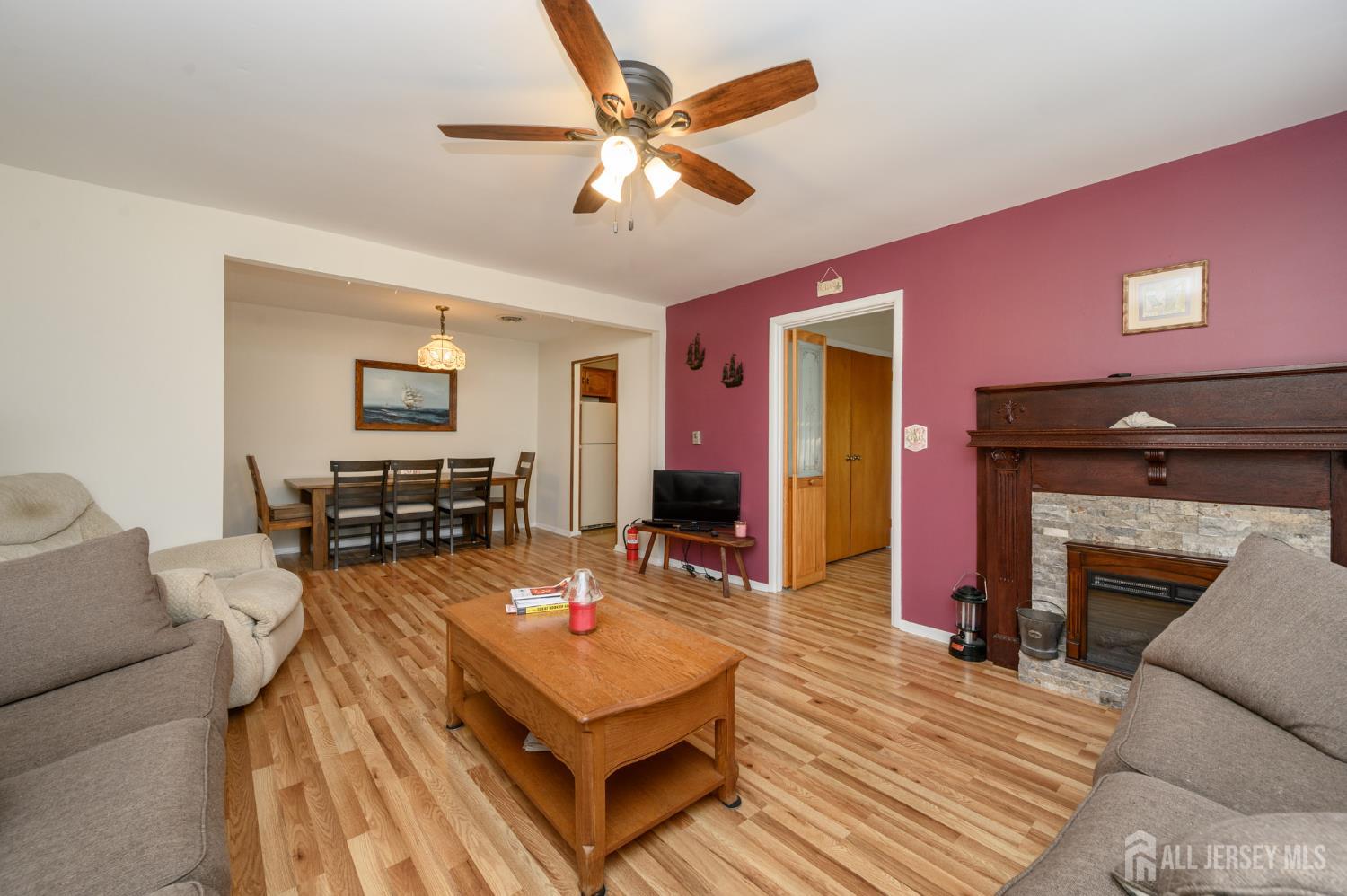 38 Cranberry Road Manahawkin, NJ 08050 - Photo 10 of 23 a living room with furniture and a fireplace