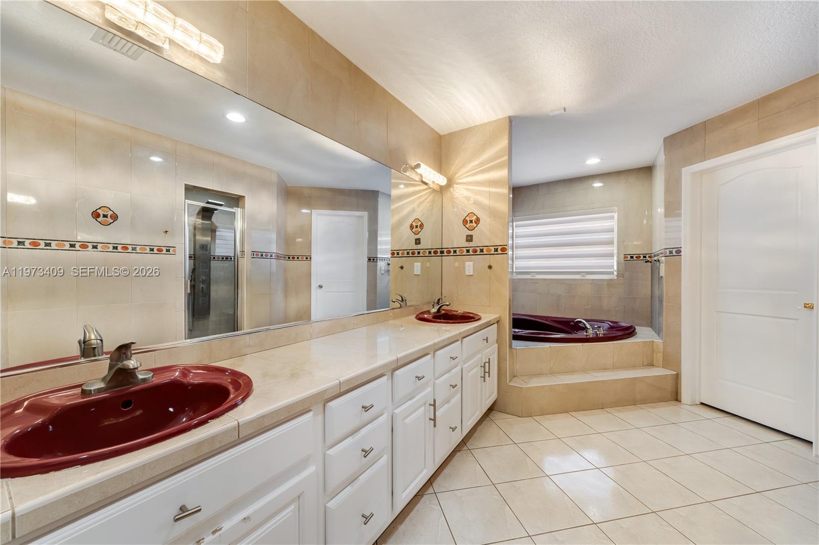 13050 Southwest 26th Street Miami, FL 33175 - Photo 20 of 43 a spacious bathroom with a double vanity sink and a mirror