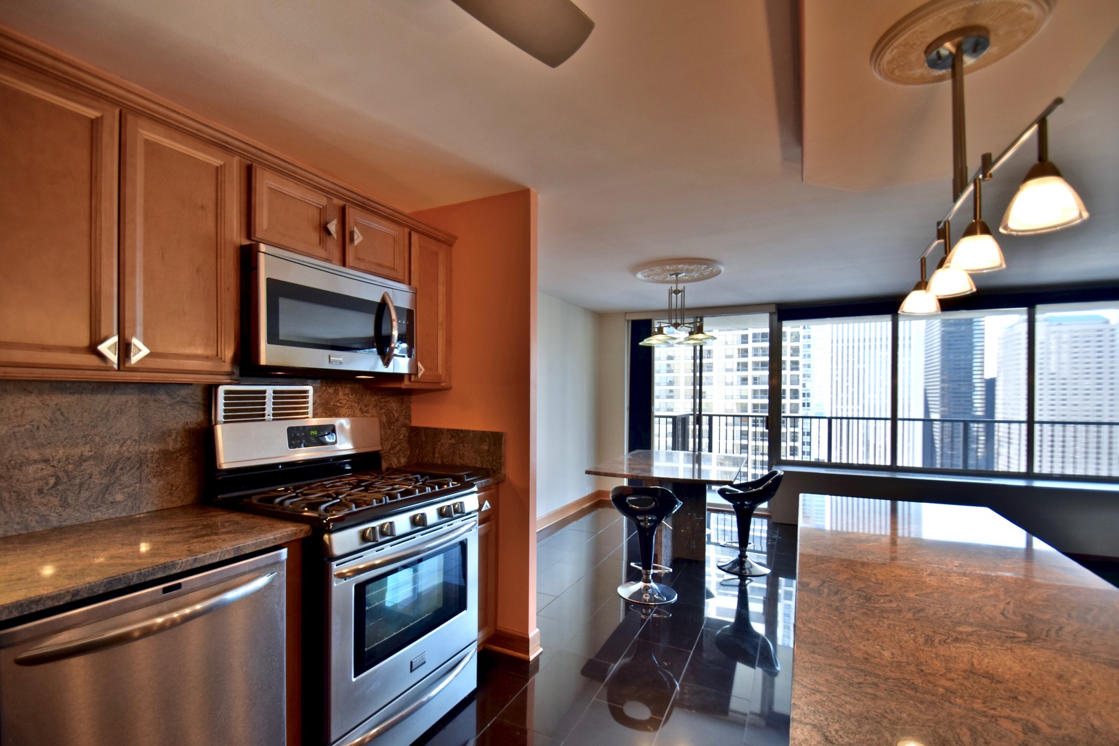 400 East Randolph Street, Unit 3326 Chicago, IL 60601 - Photo 4 of 19 a kitchen with a stove a sink and a microwave