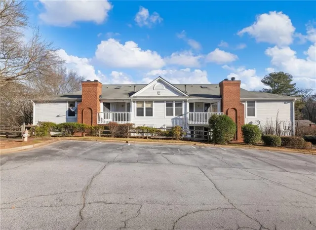 a front view of a house with a garden and pathway
