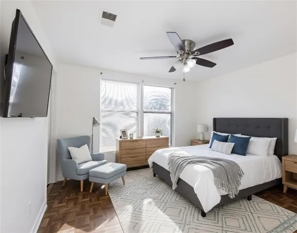 a bedroom with a bed and a chandelier