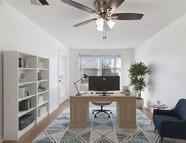 a view of a workspace with furniture