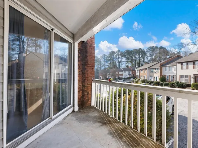 a view of a balcony with wooden floor and city view