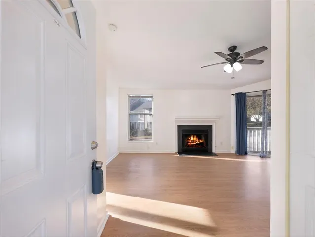 a view of a livingroom with a fireplace and a ceiling fan