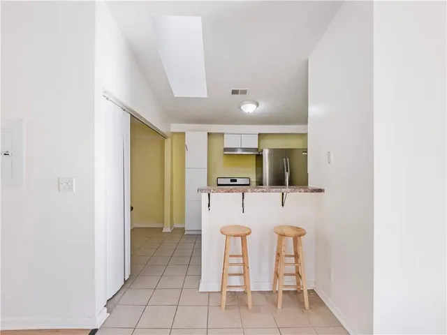 a dining room with furniture and a window