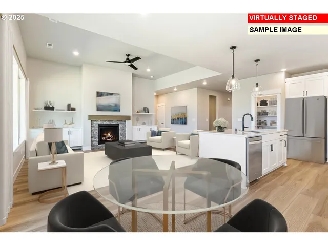 a living room with furniture a fireplace and kitchen view