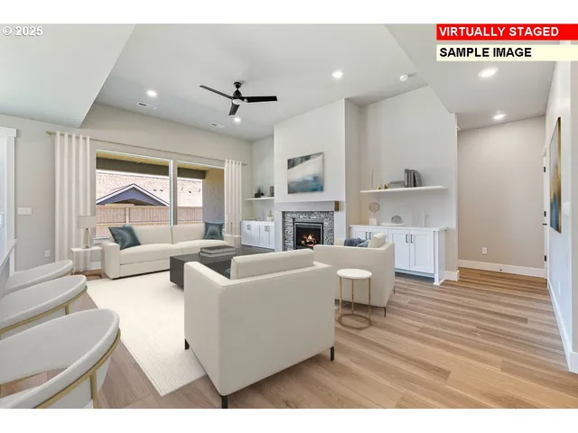 a living room with furniture a fireplace and a large window