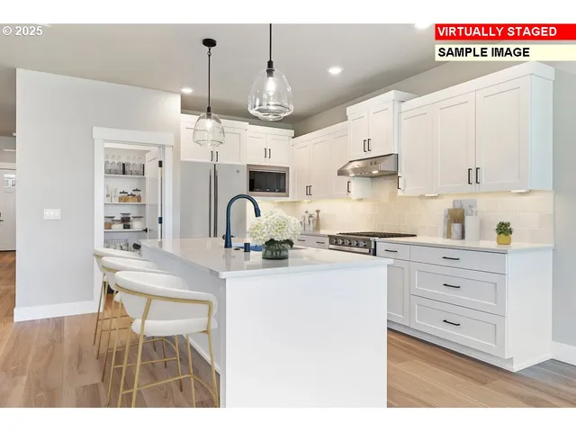 a kitchen with kitchen island white cabinets and white appliances