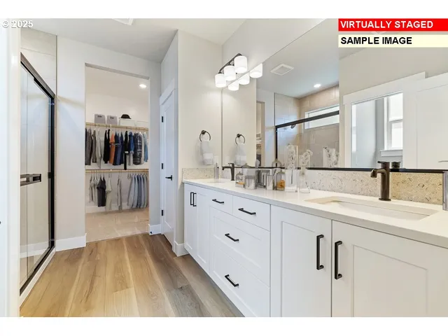 a spacious bathroom with a sink a mirror and shower