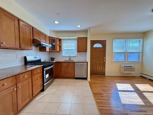 a large kitchen with stainless steel appliances granite countertop a stove a sink dishwasher and a refrigerator