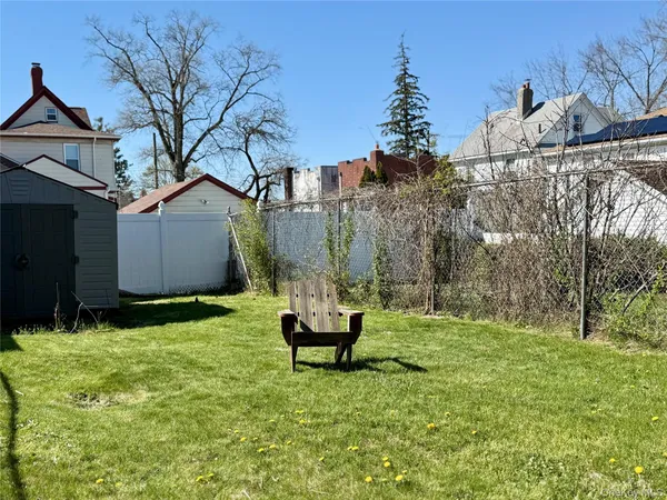 a backyard of a house with table and chairs