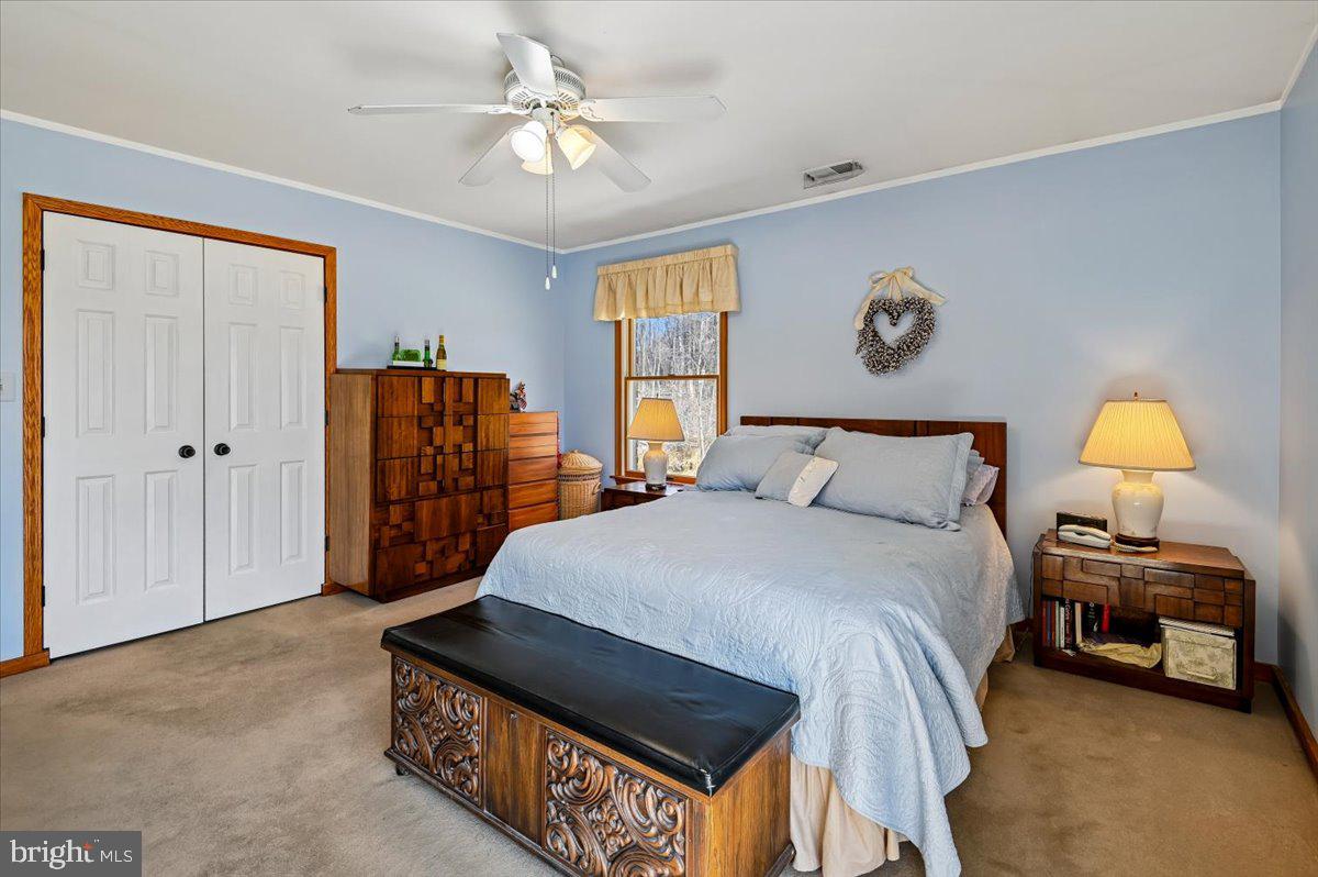 705 Marshall Manor Drive Silver Spring, MD 20905 - Photo 18 of 54 a bedroom with a bed and a chandelier