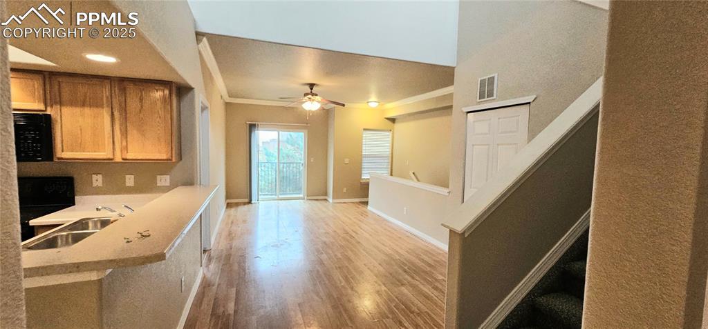 6967 Stetson Ranch Point, Unit 204 Colorado Springs, CO 80922 - Photo 13 of 19 a view of a hallway with wooden floor and entryway