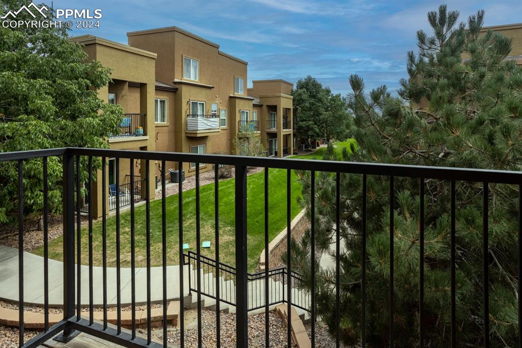 6967 Stetson Ranch Point, Unit 204 Colorado Springs, CO 80922 - Photo 5 of 19 a view of a balcony with a floor to ceiling window and wooden fence