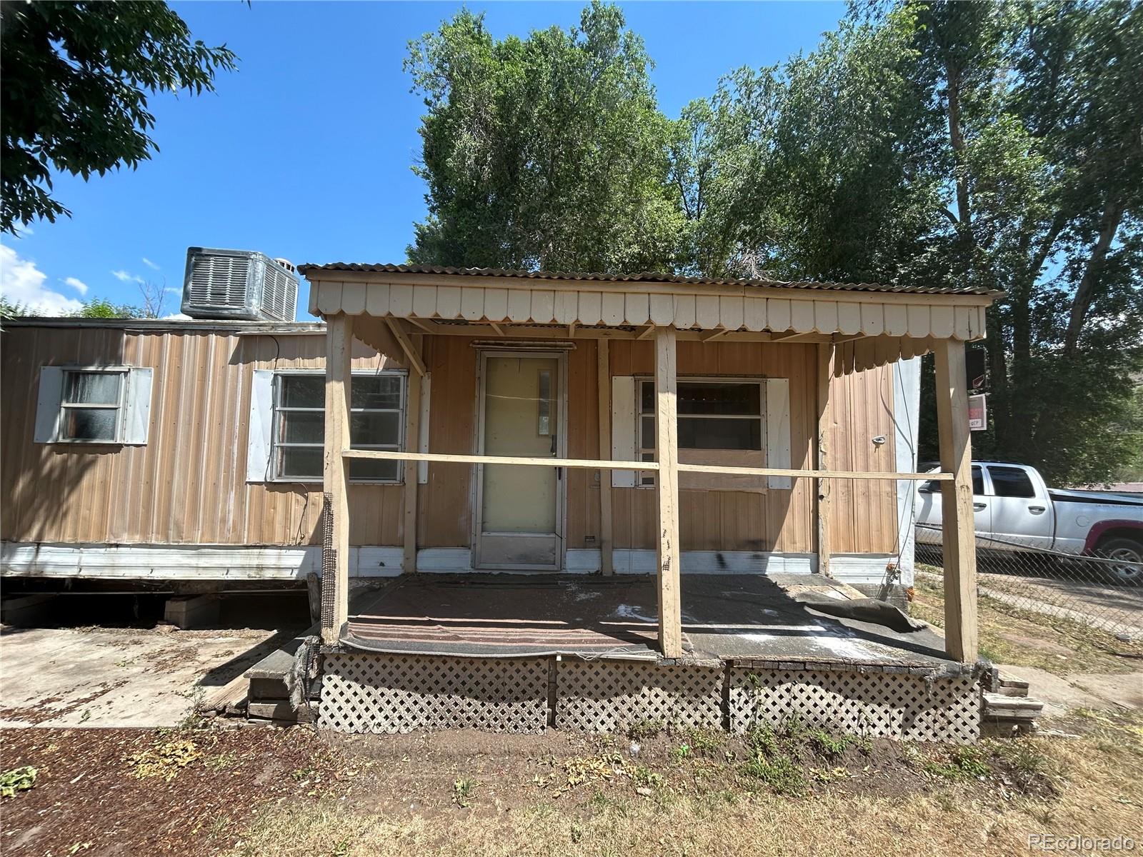 a view of a house with wooden door and a floor to ceiling window