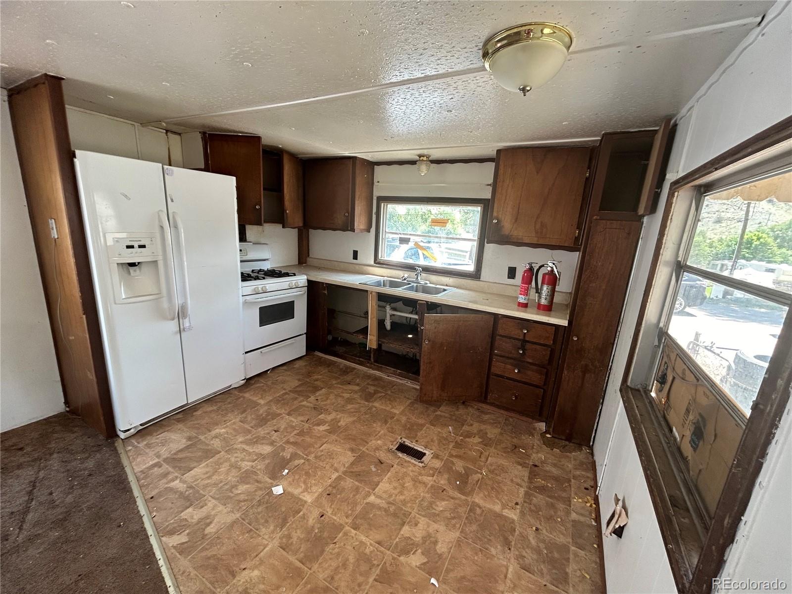 226 Scott Street Salida, CO 81201 - Photo 7 of 15 a room with window a refrigerator and a dresser