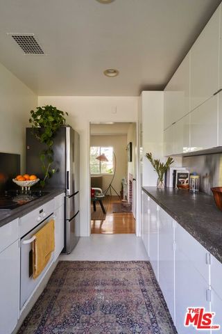 a large kitchen with stainless steel appliances granite countertop a sink and cabinets