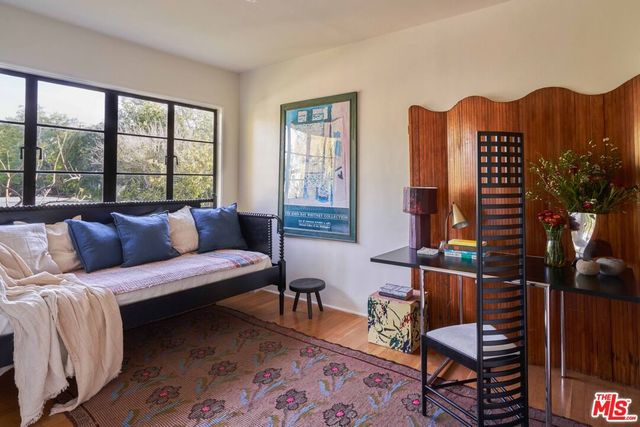 a living room with furniture a lamp and a window