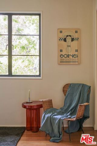 a bedroom with a bed and a lamp next to a window