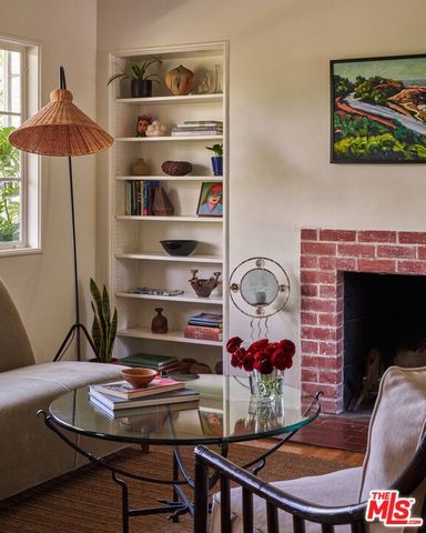 a living room with furniture a rug and a fireplace