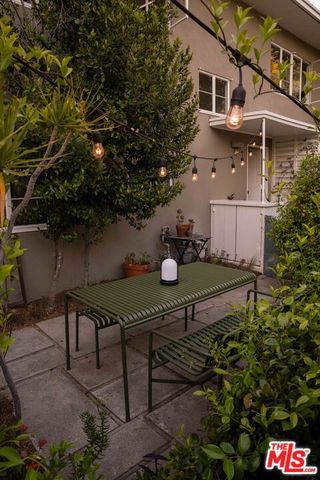 a backyard of a house with table and chairs
