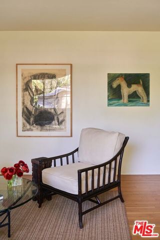 a view of a bedroom with furniture and wooden floor