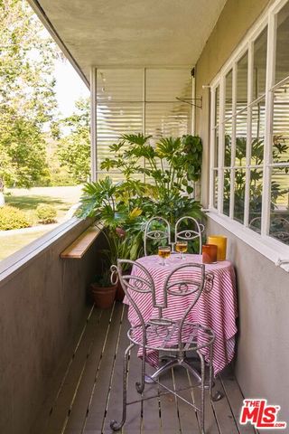 a view of balcony with a potted plant and outdoor seating
