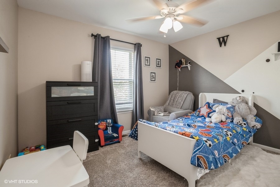 5426 Cloverdale Road Hanover Park, IL 60133 - Photo 14 of 22 a bedroom with bed and a chandelier