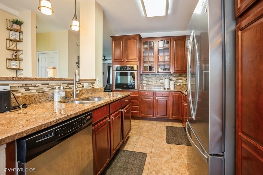 5426 Cloverdale Road Hanover Park, IL 60133 - Photo 5 of 22 a kitchen with kitchen island granite countertop a sink and a large window