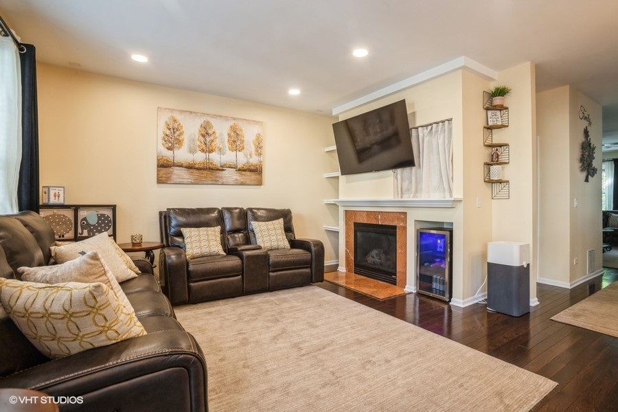 5426 Cloverdale Road Hanover Park, IL 60133 - Photo 9 of 22 a living room with furniture fireplace and flat screen tv