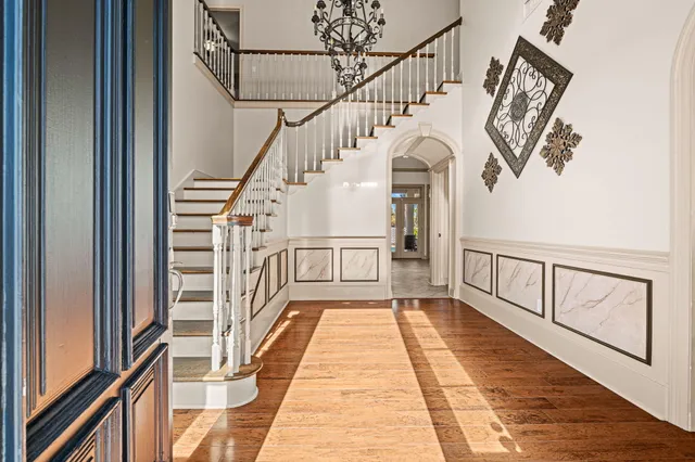 a view of entryway and hall with wooden floor