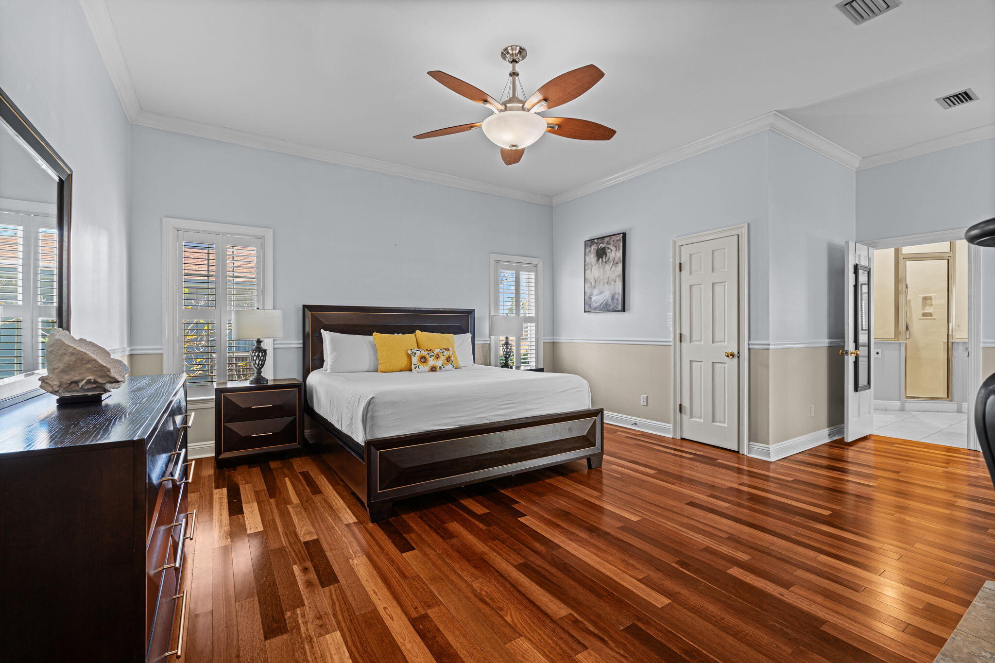 322 Wahoo Road Panama City Beach, FL 32408 - Photo 17 of 38 a bedroom with a bed and wooden floor