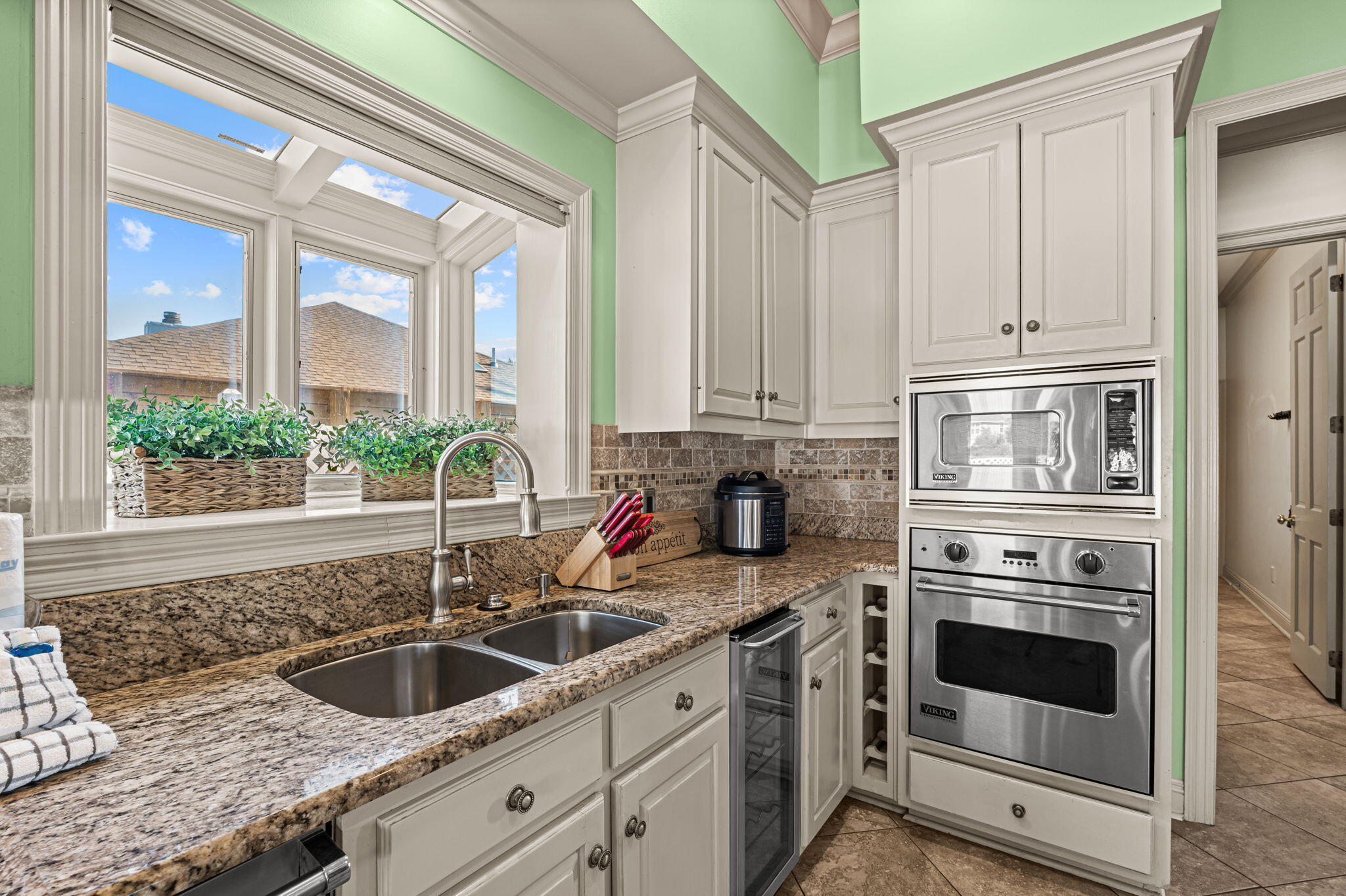 322 Wahoo Road Panama City Beach, FL 32408 - Photo 19 of 57 a kitchen with granite countertop a sink and a stove