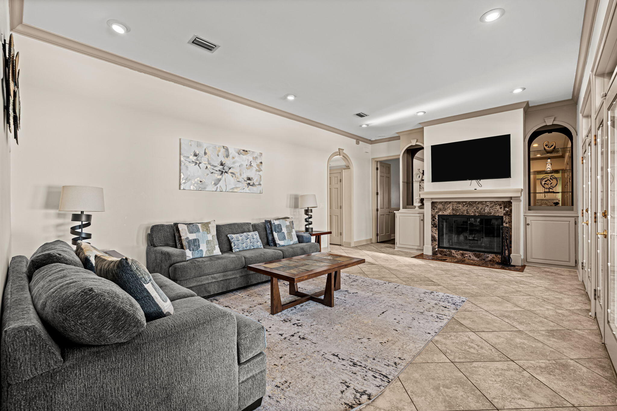 322 Wahoo Road Panama City Beach, FL 32408 - Photo 24 of 57 a living room with furniture a flat screen tv and a fireplace