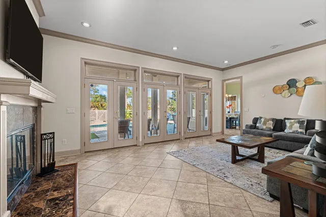 a spacious bedroom with a bed and a flat screen tv