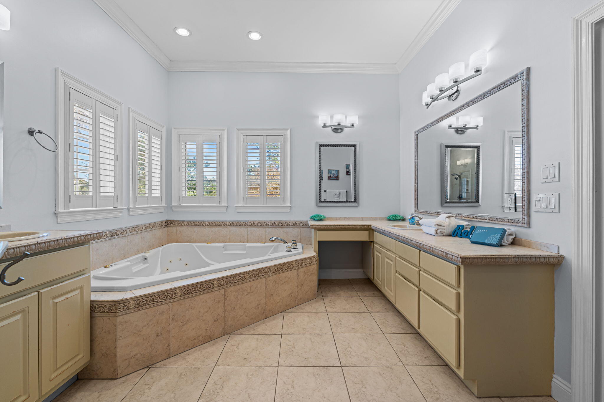 322 Wahoo Road Panama City Beach, FL 32408 - Photo 32 of 57 a spacious bathroom with a tub a sink and mirror